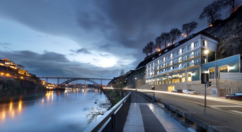 Outside building of the Eurostars Porto Douro Hotel sunset with view to Douro River and Ponte Luis I