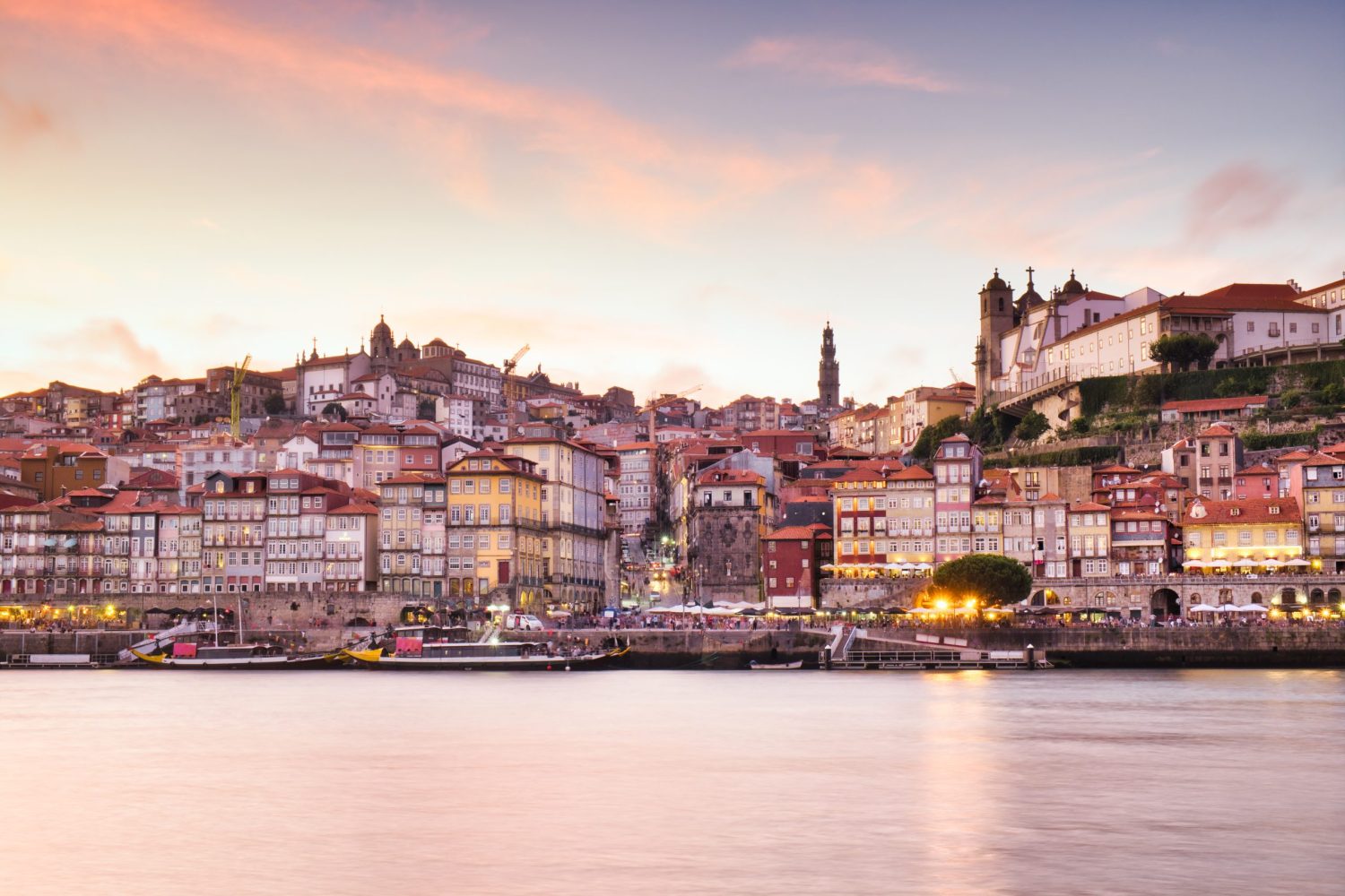 Picturesque View of Old Houses And Buildings Of Porto - Oporto - And The Douro River At Sunset. Copy Space